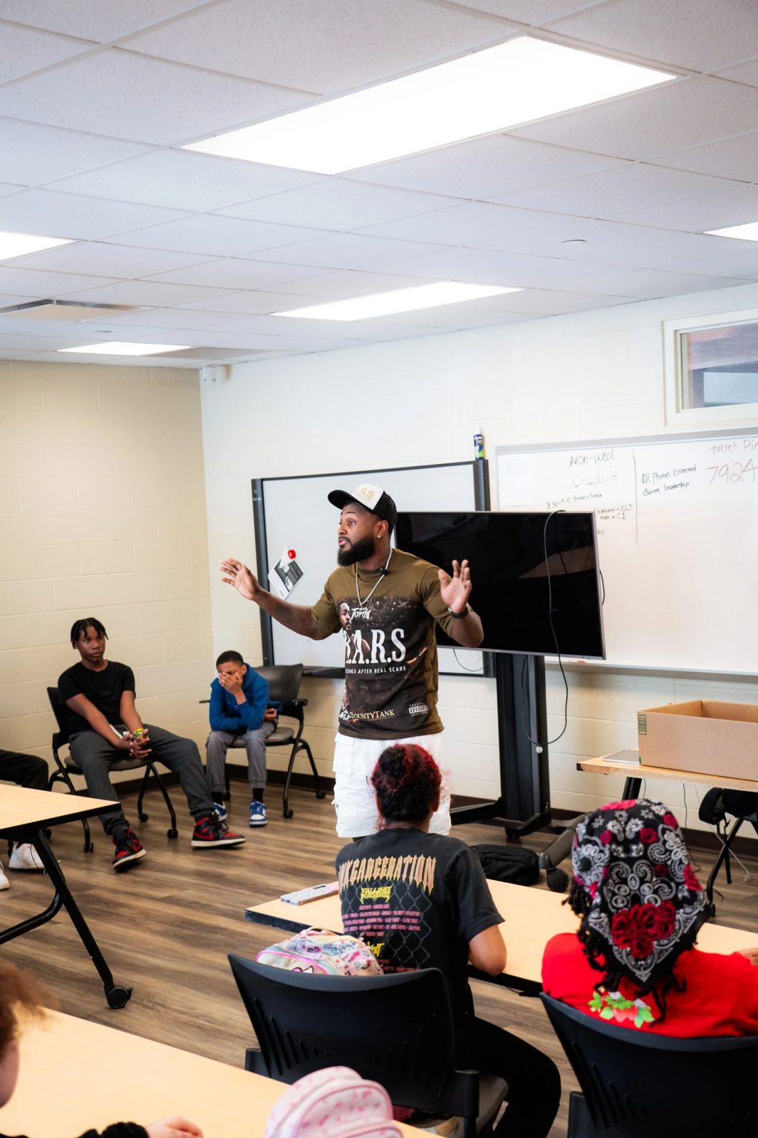Tank talking with students at Akron Reach