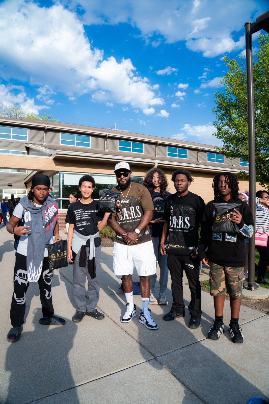 Tank with a group of Akron Reach students outside