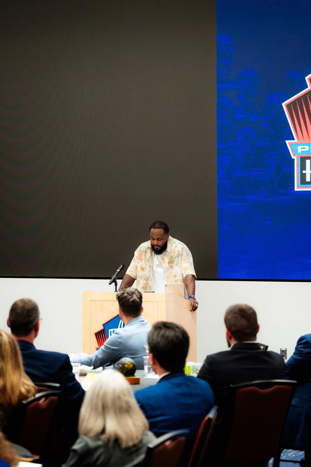 Tank at the podium at the Pro Football Hall of Fame