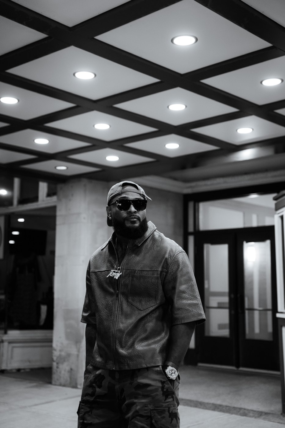 Frank "BountyTank" Frazier in a leather jacket and sunglasses, black and white portrait